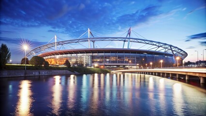 A modern stadium suspended over a river at night, with a bridge connecting to the main road , stadion