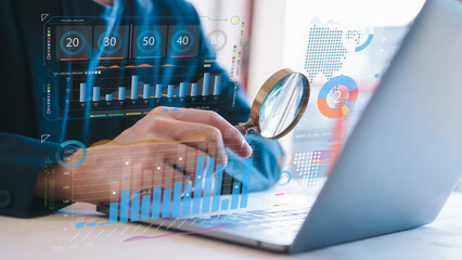 businessman holding magnifying glass looking at virtual data chart dashboard in concept of...