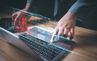 Hacker or programmer using laptop with triangle caution warning sign, coding, cryptography, hacker, crime, virus, for notification error and maintenance concept. Computer with red warning sign.