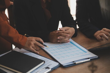 Lawyer, legal advisor, businessman brainstorming information on agreement details Business contracts in legal processing books for accuracy in contract documents. joint financial investment.