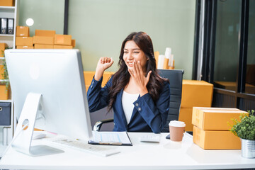 A young Asian businesswoman sits at her table, watching the computer screen.She analyzes, plans,...