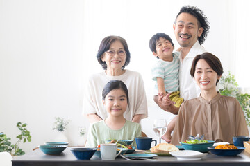 Family dining table, including three generations (two-family house) Smile for the camera Close-up of father, mother, grandmother, daughter, and five sons