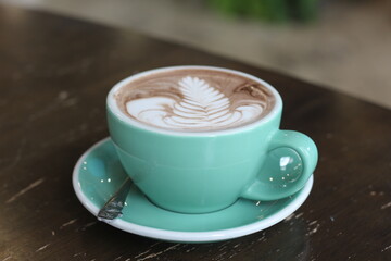 Hot chocolate on wooden table in cafe