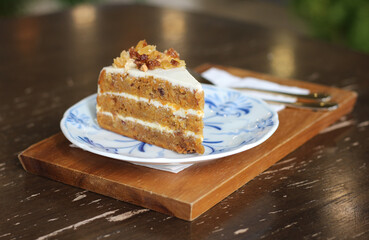 Carrot cake in plate on table at cafe