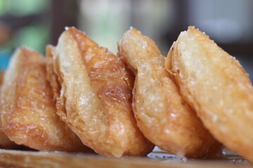 Crispy bread with sweetened condensed milk on table in coffee shop.