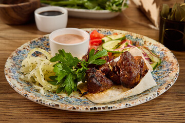 Grilled Meat Skewers with Vegetables and Onions on a Ceramic Plate