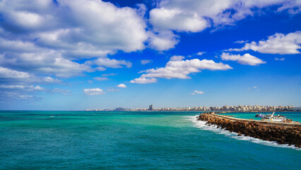 Brilliant blue of the Mediterranean sea with bright blue skies and the Alexandria city skyline seen from  the Citadel of Qaitbay,built by the Mamluk Sultan Qaitbay  at Pharos Island,Alexandria,Egypt