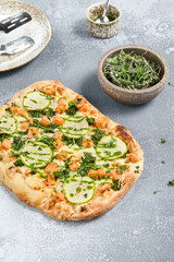 Roman Pizza with Zucchini and Salmon Toppings on Rustic Background