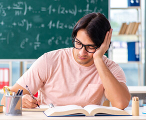 Young male student in the classroom