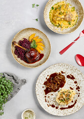 Delicious Hot Entrees Plated on Concrete Tabletop with Artistic Presentation and Garnishes