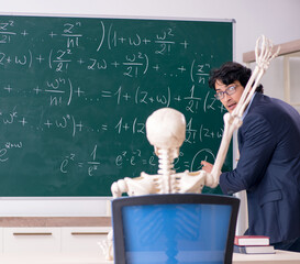 Young male math teacher and student skeleton