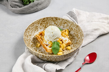 Viennese Waffle with Pears and Ice Cream on a Rustic Plate with Red Spoon