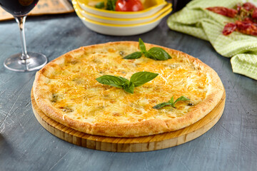 Delicious Four Cheese Pizza on Wooden Board with Basil Garnish in Rustic Setting
