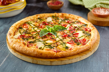 Delicious Margherita Pizza with Pesto Sauce on Wooden Board - Authentic Italian Cuisine