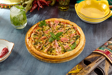 Gourmet Smoked Salmon Pizza with Pesto Sauce on Rustic Table