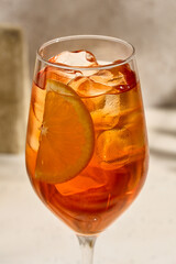 Aperol Spritz Cocktail with Orange Slice and Ice in Wine Glass