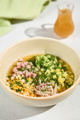 Traditional Okroshka with Kvass - Refreshing Russian Cold Soup with Diced Vegetables and Ham