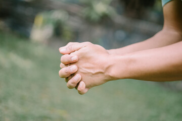 A close-up of a hand gripping its own wrist, capturing a moment of self-hold or contemplation, perfect for lifestyle