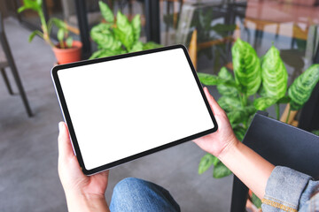 Mockup image of a woman holding digital tablet with blank white desktop screen
