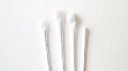 This shows four white cotton swabs with different sized heads, placed on a white background.

