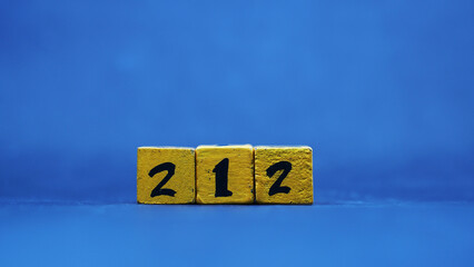 The wooden block shows the number 212