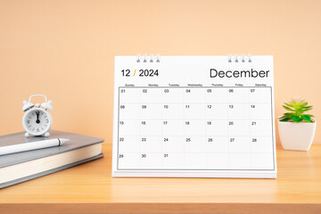 December 2024, Monthly desk calendar for 2024 year on wooden table.