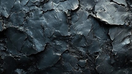 Fototapeta premium the close-up texture of a dark stone or concrete surface with cracks and natural formations.