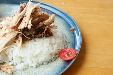 Delicious plate of flavorful chicken, perfectly cooked rice, and fresh cherry tomatoes