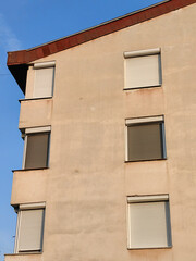 Windows with Closed Blinds: Protecting from the Sun – Sunrise and a New Dawn in the City. Symmetry of the building.