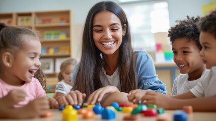 Teacher and children playing with building blocks in kindergarten
