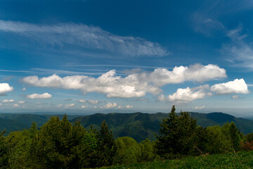 Expansive view mountain range with fluffy clouds.