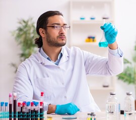 Young male chemist working in the lab