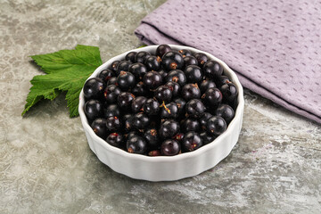 Ripe black currant in the bowl