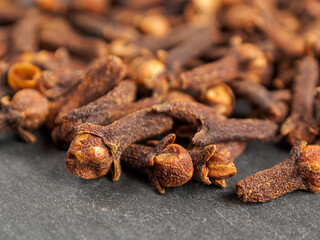 A close-up of aromatic cloves, highlighting the texture and rich color