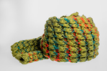 Close-up of a bright green knitted wool scarf. Detailed texture and rich color highlight the quality and comfort of this stylish