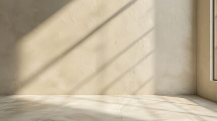 Sunlight streams through a window onto a beige wall and floor, casting long shadows across the room. The light illuminates the floor, creating a bright, inviting space.