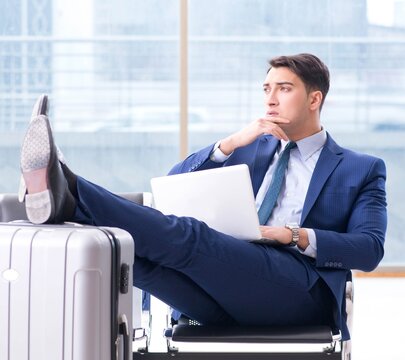 Businessman waiting at the airport for his plane in business cla