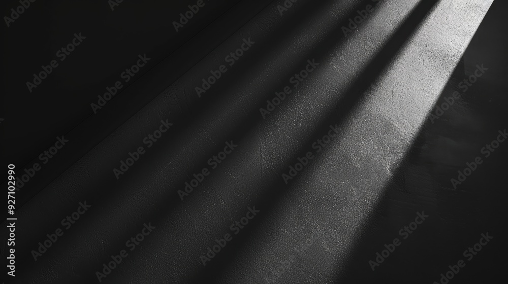 Poster Light from a window streams across a dark, textured wall. The rays of light cast long, thin shadows on the surface, illuminating the texture and creating a sense of depth.