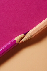 Pink and purple colored pencils on coordinated paper