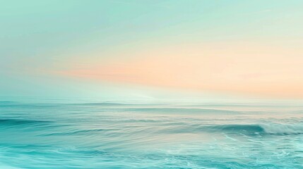Fototapeta premium The image captures a serene scene of the ocean at dawn. Soft, pale pink and blue hues color the sky as the sun rises, casting a gentle light on the rippling water below. The waves gently roll towards 
