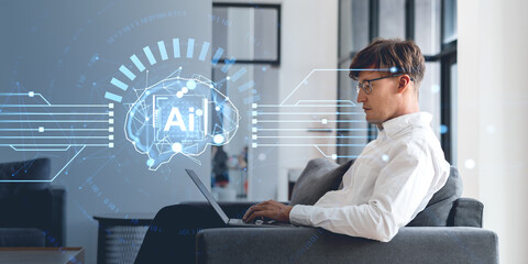 Man using laptop with AI interface overlay in modern office.