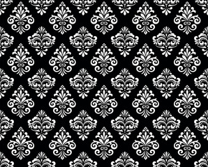 Floral pattern. Vintage wallpaper in the Baroque style. Seamless vector background. White and black ornament for fabric, wallpaper, packaging. Ornate Damask flower ornament.