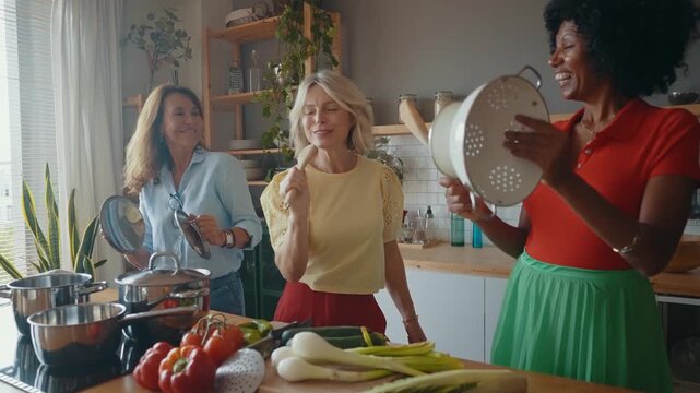 Cinematic image of a group of senior women cooking and having fun at home. Reunion and social gathering of three female friends in a beautiful kitchen.