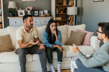 Marriage Restoration. Cheerful Couple Talking To Marital Counselor At Their Home
