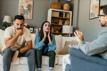 Young couple having a counseling session with therapist at home