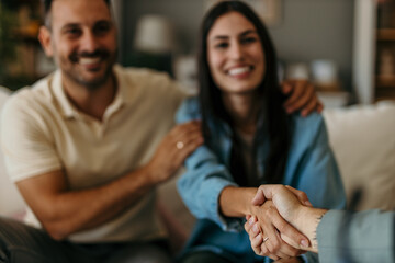 Happy man and woman clients handshake close deal with a legal adviser