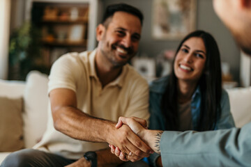 The young happy couple and an agent in a new property, or a professional psychologist advising...