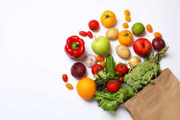 Delivery of vegetarian products. Bag with different vegetables and fruits on white background, top view