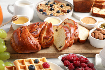 Different meals served for breakfast on white table