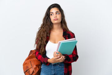 Young student woman isolated on white background and looking up